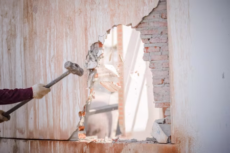 man working wood against wall 1048944 9226602 man working wood against wall 1048944 9226602